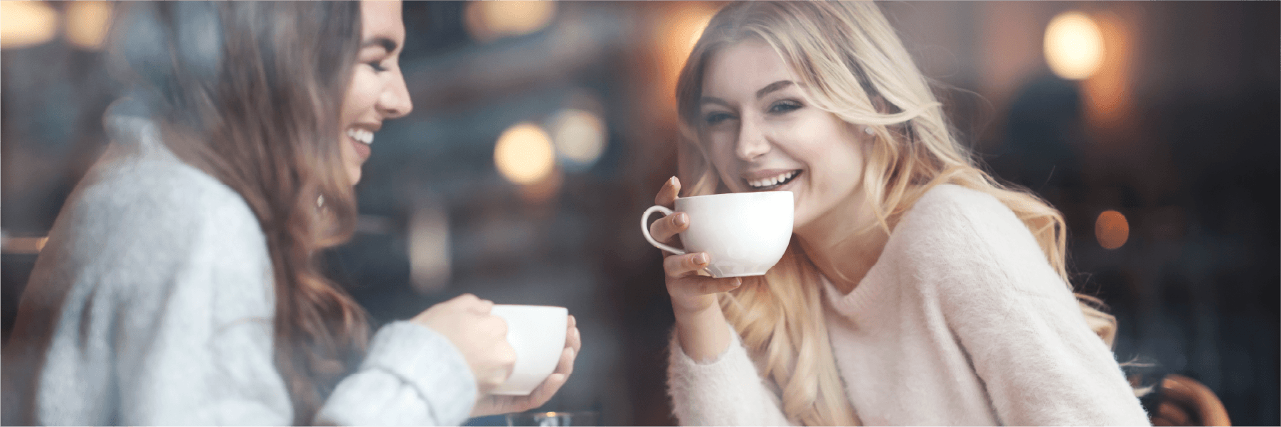 2 woman enjoying a hot drink together