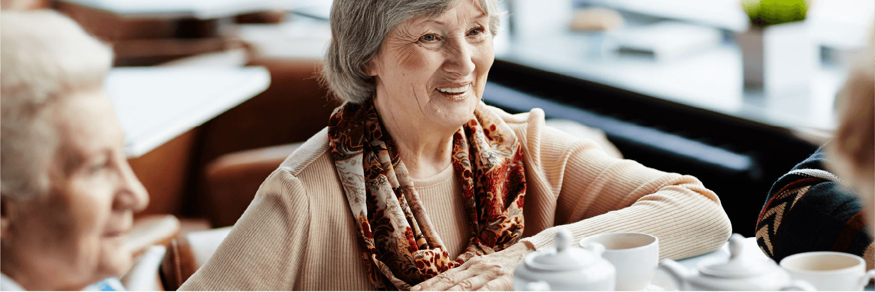 elderly lady enjoying coffee with friends